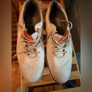white FootJoy FJ PRO/SL men's spikeless golf shoes with orange accents